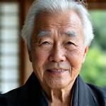 Portrait of Master Hiroshi Tanaka, an elder Japanese man with a serene expression and traditional clothes, in a garden setting.